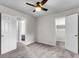 Neutral bedroom with multiple doorways showcasing closet space and flow; features ceiling fan and carpet at 2362 Parsonage Rd # 2H, Charleston, SC 29414