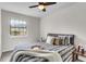 Cozy bedroom featuring a ceiling fan, a patterned bedspread, and a bright window with a view at 2362 Parsonage Rd # 2H, Charleston, SC 29414