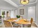 Cozy dining room with seating for six under modern lighting with view of landscaped exterior at 2362 Parsonage Rd # 2H, Charleston, SC 29414
