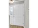 Bright white door and sidelight, showing the foyer space and wood flooring at 2362 Parsonage Rd # 2H, Charleston, SC 29414
