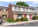 A cozy townhouse with brick and siding, black shutters, and a vibrant red door, enhancing curb appeal at 2362 Parsonage Rd # 2H, Charleston, SC 29414