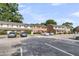Community exterior view, well-maintained with ample parking and colorful entry doors, set against a blue sky at 2362 Parsonage Rd # 2H, Charleston, SC 29414