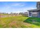 Large grassy backyard with a wooden fence and view of neighboring houses at 240 Lucca Dr, Summerville, SC 29486