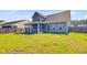 Expansive backyard with green grass, a screened-in porch, and privacy fencing, perfect for outdoor activities at 240 Lucca Dr, Summerville, SC 29486