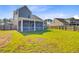 Large backyard with lawn, screened-in porch, and wooden fence for privacy at 240 Lucca Dr, Summerville, SC 29486