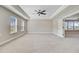 Spacious bedroom featuring plush carpeting, tray ceilings, large windows, and a serene atmosphere at 240 Lucca Dr, Summerville, SC 29486