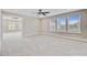 Neutral bedroom with plush carpeting, three windows, and a ceiling fan at 240 Lucca Dr, Summerville, SC 29486
