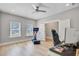 Bright bonus room with sleek ceiling fan, wood floors, neutral paint, Peloton, desk and gaming chair at 240 Lucca Dr, Summerville, SC 29486