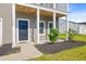 Close-up view of front entrance featuring a charming covered porch and manicured landscaping at 240 Lucca Dr, Summerville, SC 29486