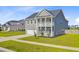 Lovely two-story home boasts a second-story balcony, attached garage, and beautifully landscaped front yard at 240 Lucca Dr, Summerville, SC 29486