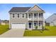 Charming two-story home with a welcoming front porch and a two-car garage, nestled in a serene neighborhood at 240 Lucca Dr, Summerville, SC 29486