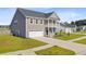 Attractive two-story home featuring a cozy balcony, attached garage, and a lush green lawn at 240 Lucca Dr, Summerville, SC 29486