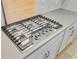 Close up of gas cooktop with light countertop and white cabinets at 240 Lucca Dr, Summerville, SC 29486