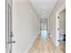 Bright hallway with wood floors, leading to various rooms and offering a view of the outdoors at 240 Lucca Dr, Summerville, SC 29486