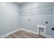 Compact laundry room with vinyl floors, utility connections, and wire rack shelving at 240 Lucca Dr, Summerville, SC 29486