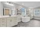 Bright main bathroom featuring double sinks, free-standing tub, neutral paint, and modern fixtures at 240 Lucca Dr, Summerville, SC 29486