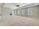 Spacious main bedroom features tray ceiling, ceiling fan, large windows, and ensuite bathroom entrance at 240 Lucca Dr, Summerville, SC 29486