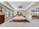Comfortable primary bedroom featuring a ceiling fan, carpet, with access to a seating area and en-suite bathroom at 240 Lucca Dr, Summerville, SC 29486