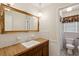 Bathroom vanity with a wood countertop, white cabinets, and a large framed mirror at 2425 Vistavia Rd, North Charleston, SC 29406