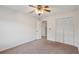 Bright bedroom featuring neutral carpet, ceiling fan, and double closet, perfect for relaxation at 2425 Vistavia Rd, North Charleston, SC 29406