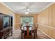 Formal dining room featuring elegant wainscoting, chandelier, and a large wood table at 2425 Vistavia Rd, North Charleston, SC 29406