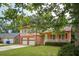 Attractive home showcasing a two-car garage, green lawn, and a welcoming front porch area at 2425 Vistavia Rd, North Charleston, SC 29406
