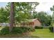 Traditional-style home with a manicured lawn, mature trees, and a charming front porch at 2425 Vistavia Rd, North Charleston, SC 29406