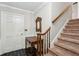 Entryway featuring hardwood floors, stairs, and a wooden accent table with mirror at 2425 Vistavia Rd, North Charleston, SC 29406