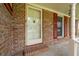 Close-up of the front door and porch area, highlighting brickwork and charming details at 2425 Vistavia Rd, North Charleston, SC 29406