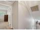 Upstairs hallway with neutral walls, carpet, and views into a bedroom and another room at 2425 Vistavia Rd, North Charleston, SC 29406