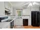 Bright kitchen with white cabinets, laminate counters, and black appliances at 2425 Vistavia Rd, North Charleston, SC 29406