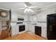 Well-lit kitchen with white cabinetry, functional appliances, and laminate wood flooring at 2425 Vistavia Rd, North Charleston, SC 29406