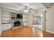 Inviting living room featuring a brick fireplace, wood floors, and sliding doors leading to the sunroom at 2425 Vistavia Rd, North Charleston, SC 29406