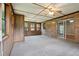 Bright sunroom featuring brick and wood paneling, carpet floors, and large windows overlooking the yard at 2425 Vistavia Rd, North Charleston, SC 29406
