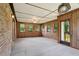 Large sunroom with brick and wood accents, carpet, and multiple windows for ample natural light at 2425 Vistavia Rd, North Charleston, SC 29406