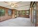 Spacious sunroom with wood paneling, large windows, and access to the backyard at 2425 Vistavia Rd, North Charleston, SC 29406