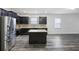 Modern kitchen featuring dark cabinets, granite countertops, stainless steel appliances, and a center island at 278 Decatur Dr, Summerville, SC 29483