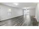 A bright living room boasting plenty of space, wood-look floors, and natural lighting at 278 Decatur Dr, Summerville, SC 29483