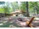 Relaxing backyard showcasing a fire pit, wooden chairs, and ample space for outdoor activities at 2831 Chicopee Dr, North Charleston, SC 29420
