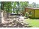 Wood fenced backyard provides privacy, with mature trees and a firepit with seating for entertaining at 2831 Chicopee Dr, North Charleston, SC 29420