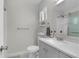 Clean bathroom with gray vanity, white countertop, a large mirror, and shower featuring glass doors at 2831 Chicopee Dr, North Charleston, SC 29420