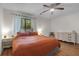 A well-lit bedroom includes a ceiling fan, window with curtains, and a dresser for ample storage at 2831 Chicopee Dr, North Charleston, SC 29420