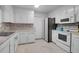 Well-equipped kitchen features white cabinets, stainless steel refrigerator, oven, and tiled backsplash at 2831 Chicopee Dr, North Charleston, SC 29420