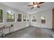 This sunroom boasts natural light from multiple windows, a ceiling fan, and a door to the outside at 2831 Chicopee Dr, North Charleston, SC 29420