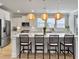Well-lit kitchen with large center island, modern appliances, barstool seating and a view to the backyard at 2889 Backman St, Mount Pleasant, SC 29466