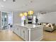 Open concept kitchen with large island, bar seating, modern pendant lights, and view into the living room at 2889 Backman St, Mount Pleasant, SC 29466