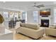Bright, open-concept living room with fireplace, modern lighting, and island seating at 2889 Backman St, Mount Pleasant, SC 29466