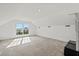 Well-lit attic featuring plush carpeting and exterior view from large window at 3095 S Shore Dr, Charleston, SC 29407