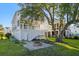 Charming backyard featuring a stone patio with fire pit and a view of the home's exterior at 3095 S Shore Dr, Charleston, SC 29407