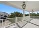 Large covered balcony with a white railing overlooking a neighborhood at 3095 S Shore Dr, Charleston, SC 29407